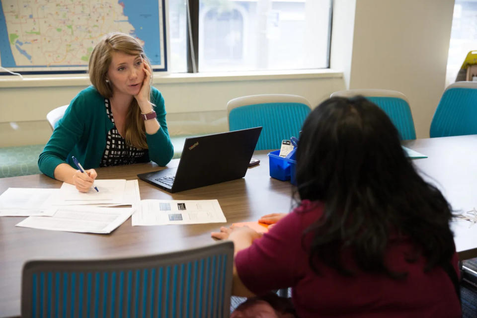 Lauren Koehler, executive director of San Francisco Unified School District’s Enrollment Center, counsels a parent hoping to enroll her child in a district school, but only if the charter school she applied to doesn’t extend an offer first. (Sonya Abrams/The Hechinger Report)