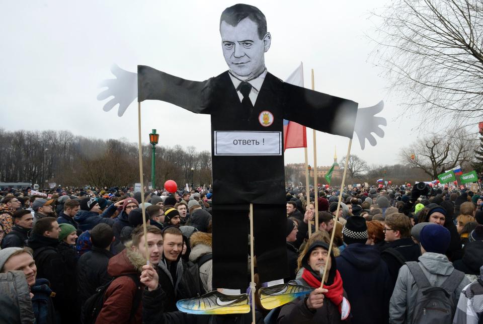 Protesters&nbsp;carry a cutout figure depicting Prime Minister Dmitry Medvedev in central Saint Petersburg.