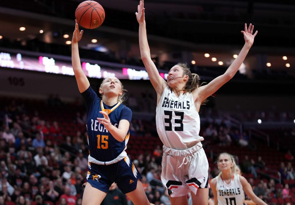 Regina Catholic sophomore Morgan Miller puts up a shot over the reach of Sibley-Ocheyedan’s Madison Brouwer during a Class 2A quarterfinal in Des Moines on Tuesday.