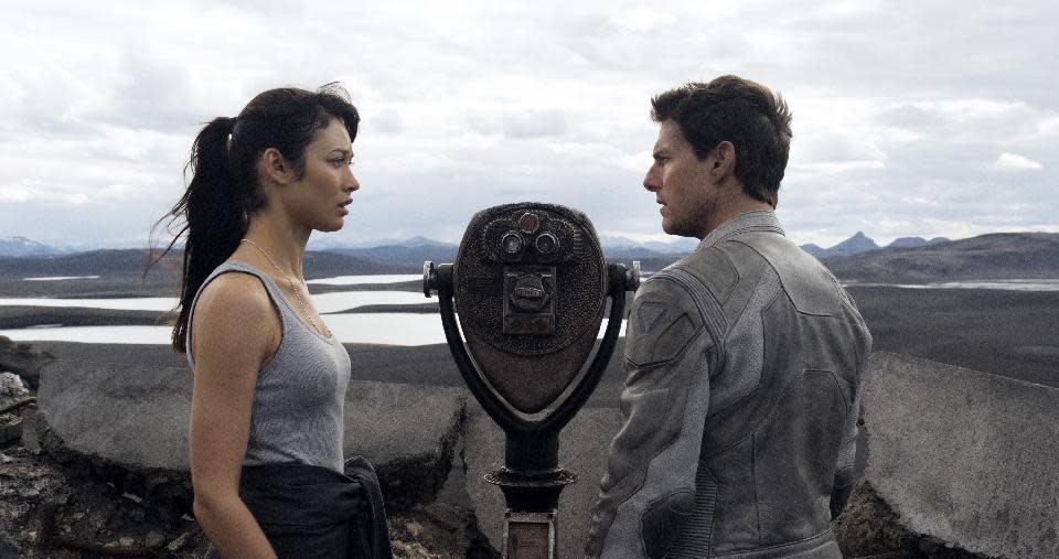 This film publicity image released by Universal Pictures shows Olga Kurylenko, left, and Tom Cruise in a scene from "Oblivion." (AP Photo/Universal Pictures)