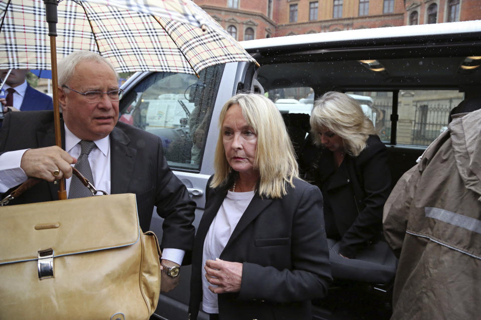 June Steenkamp, center, the mother of as Reeva Steenkamp, arrives at the high court for the start of the trial of Oscar Pistorius in Pretoria, South Africa, Monday, March 3, 2014. Pistorius is charged with murder with premeditation in the shooting death of girlfriend Reeva Steenkamp in the pre-dawn hours of Valentine's Day 2013. (AP Photo/Schalk van Zuydam)