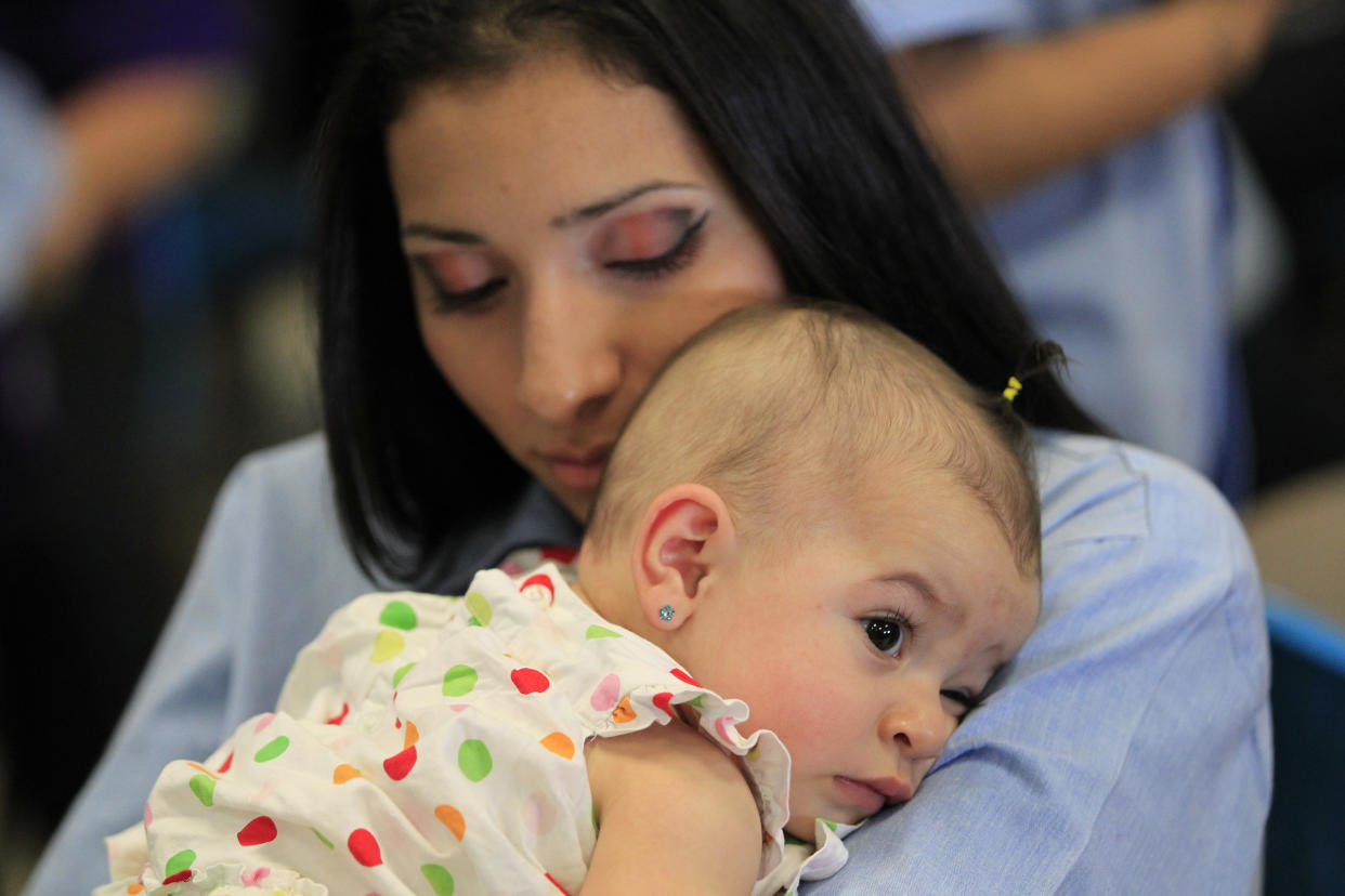 A woman hugs her baby at the California Institution for Women state prison in Chino on May 5, 2012. (Photo: Lucy Nicholson / Reuters)