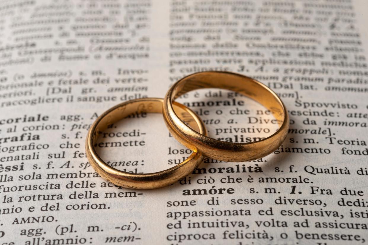 Two wedding rings on a dictionary page