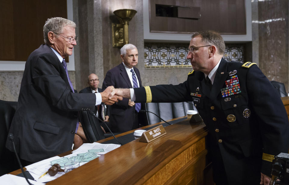 Gen. Robert Abrams, right, shakes hands with Senate Armed Services Committee Chairman Sen. James Inhofe, R-Ok., left, as ranking member Sen. Jack Reed, D-R.I., stands center, after a hearing on Capitol Hill in Washington, Tuesday, Sept. 25, 2018. Gen. Abrams is nominated to take command of U.S. and allied forces in South Korea and says the decision to cancel several major military exercises on the Korean peninsula this year caused a slight degradation in the readiness of American forces. (AP Photo/Carolyn Kaster)