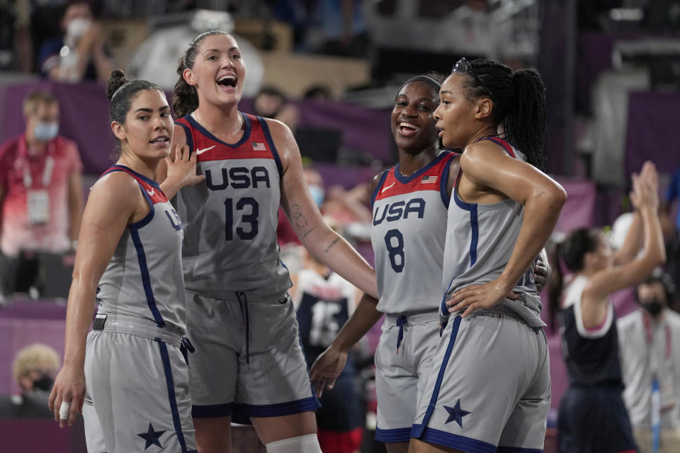 United States' Kelsey Plum, left, Stefanie Dolson (13), Jacquelyn Young (8) and Allisha Gray celebrate after defeating Russian Olympic Committee in a women's 3-on-3 gold medal basketball game at the 2020 Summer Olympics, Wednesday, July 28, 2021, in Tokyo, Japan. (AP Photo/Jeff Roberson)