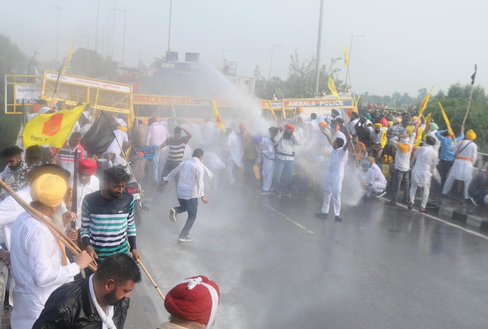 Workers of Lok Insaf Party are sprayed by a water cannon by Haryana Police during a protest against the Central government, at Punjab Haryana border on September 23, 2020 in Patiala, India. (Photo by Bharat Bhushan/Hindustan Times via Getty Images)