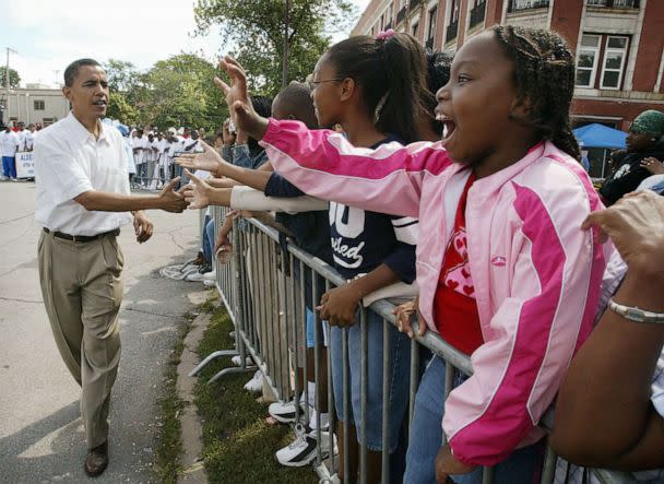 PHOTO: Barack Obama, Democratic candidate for U.S. Senate from Illinois, campaigns during the Bud Billiken parade, Aug. 14, 2004, on the South Side of Chicago. Obama marched the parade route with his wife Michelle and several hundred supporters.   (Scott Olson/Getty Images)