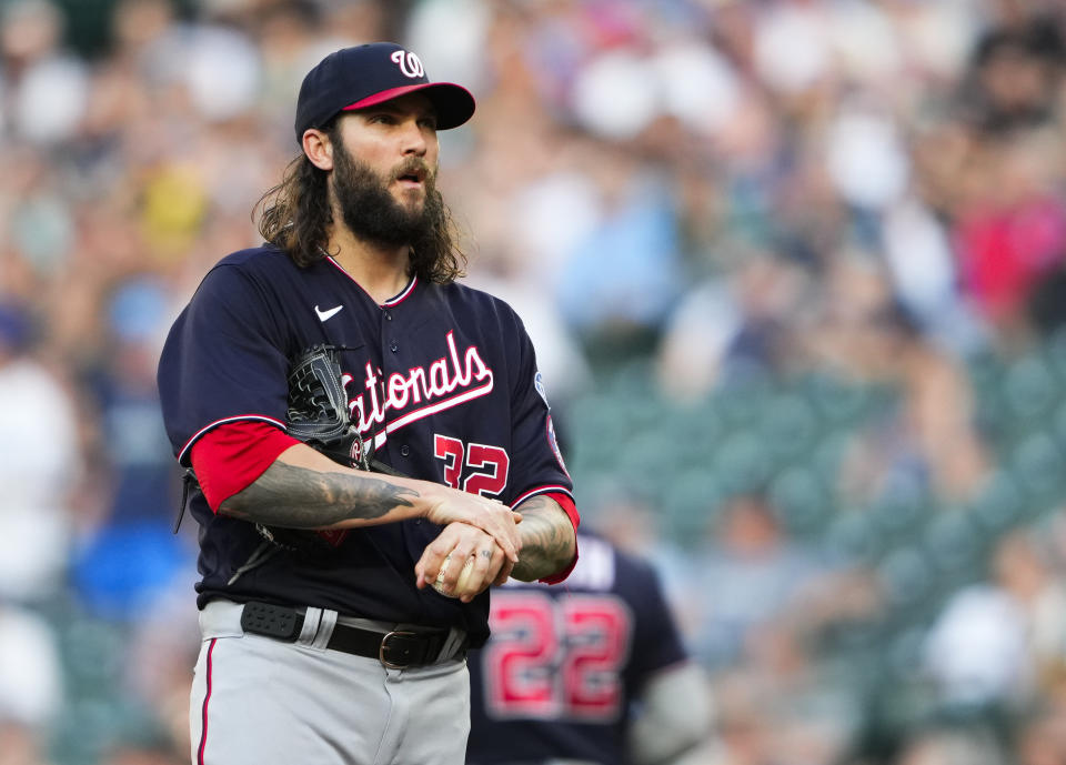 Washington Nationals starting pitcher Trevor Williams reacts after being charged with a disengagement violation while pitching to Seattle Mariners' Mike Ford, allowing Jarred Kelenic to advance from first base to second base, during the fourth inning of a baseball game Monday, June 26, 2023, in Seattle. (AP Photo/Lindsey Wasson)