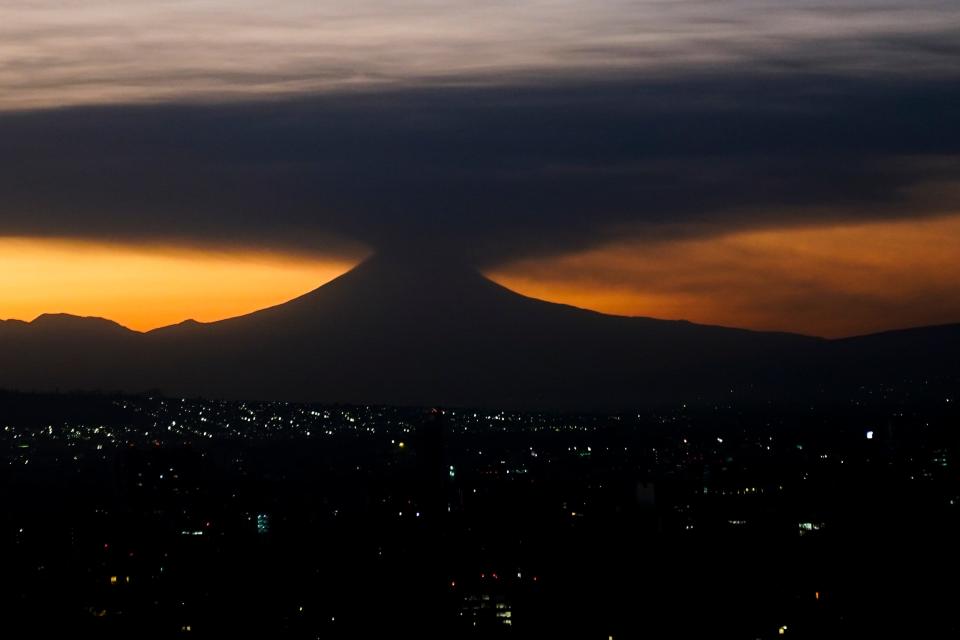 The Popocatepetl volcano emits smoke and ash, seen from Mexico City at sunrise on Tuesday, Feb. 27, 2024.