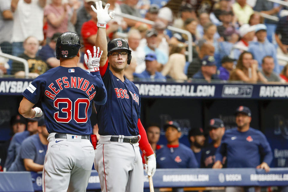 Boston Red Sox' Rob Refsnyder (30) celebrates his home run against the Tampa Bay Rays in the first inning of a baseball game at Tropicana Field in St. Petersburg, Fla., Thursday, April 13, 2023. (Ivy Ceballo/Tampa Bay Times via AP)