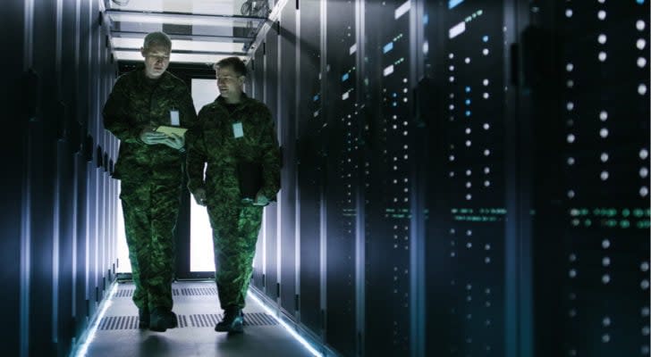 military members walking in a server room