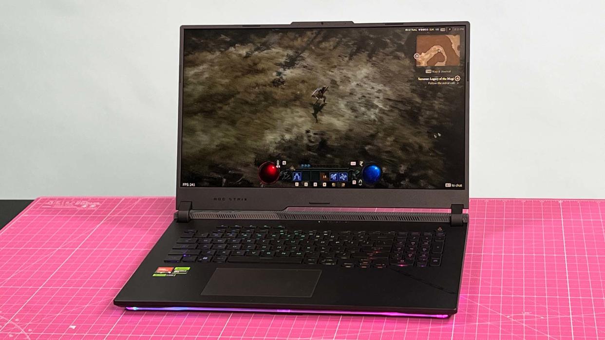  An Asus ROG Strix Scar 17 (2023) on a desk with a pink desk mat 