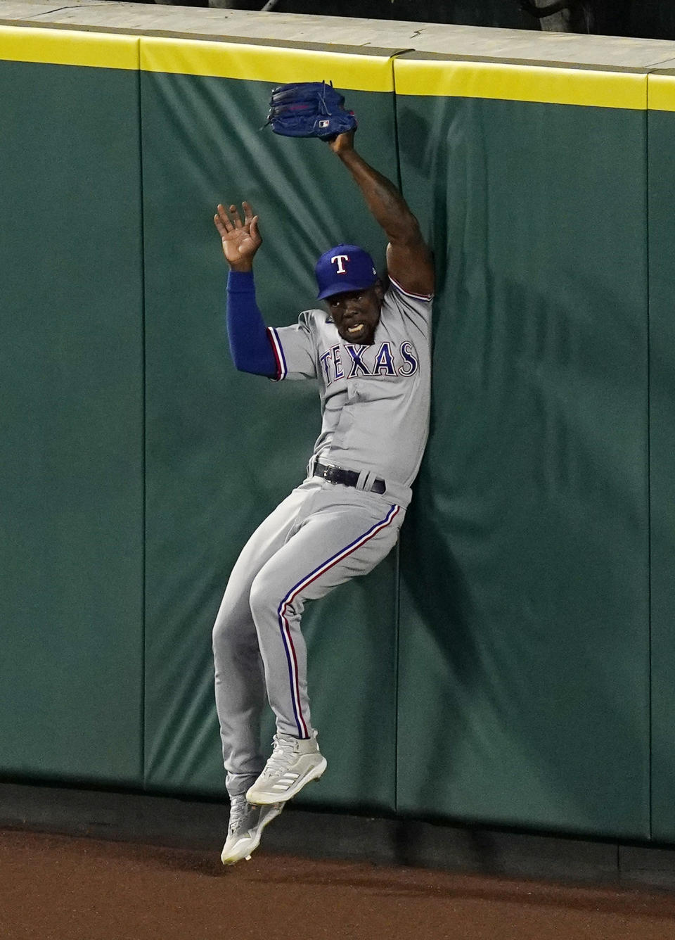 Texas Rangers right fielder Adolis Garcia hits the wall as he makes a catch on a ball hit by Los Angeles Angels' Shohei Ohtani during the fourth inning of a baseball game Monday, April 19, 2021, in Anaheim, Calif. (AP Photo/Mark J. Terrill)