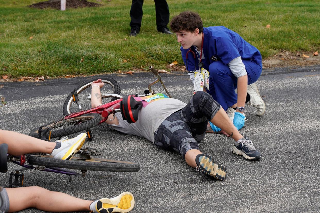 Nathan Ewing, a junior nursing student at Siena Heights University, tends to a victim Oct. 27 during a mock disaster on SHU's Adrian campus titled “Tour de Sienna," a 25-bike pileup that required the attention of nursing students from the university.