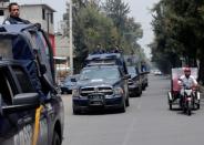 Police vehicles patrol the streets, after suspected gang members were killed on Thursday in a gun battle with Mexican marines in Mexico City, Mexico, July 21, 2017. REUTERS/Henry Romero