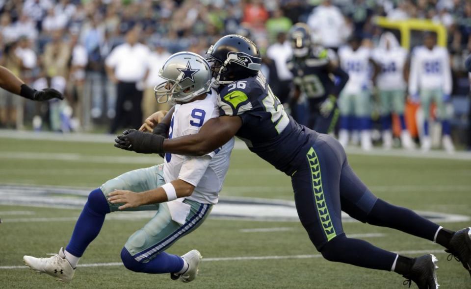 Tony Romo tackled by Cliff Avril (AP)