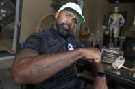 Former NFL football player Charles Woodson shows his Lombardi Trophy tattoo during an interview at his home, Tuesday, June 15, 2021, in Orlando, Fla. (AP Photo/Phelan M. Ebenhack)