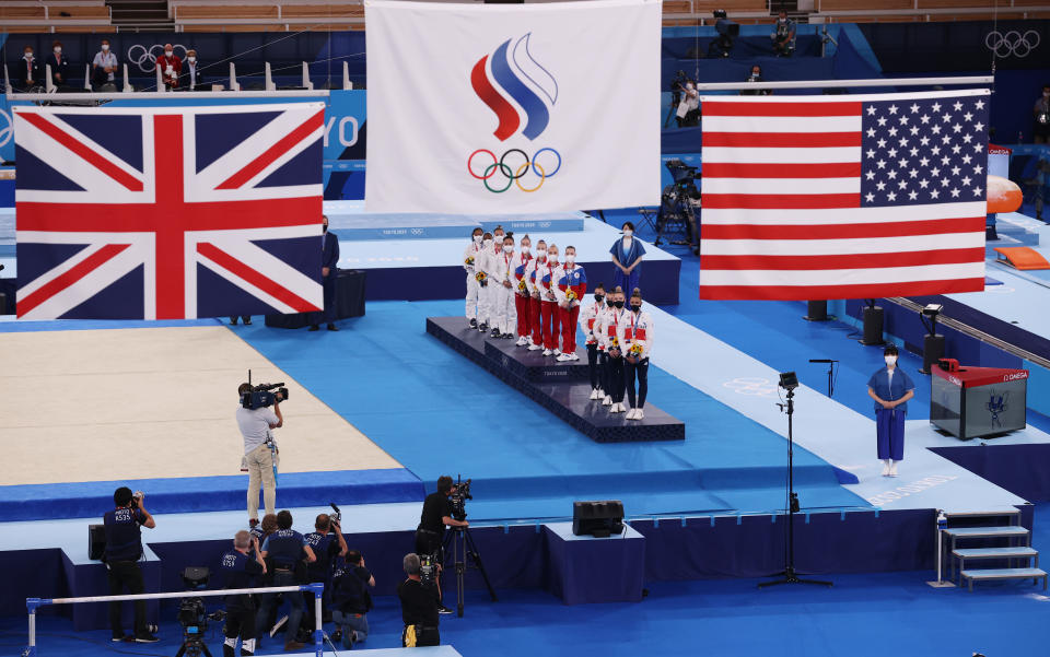 TOKYO, JAPAN - JULY 27: Team United States, Team ROC, and Team Great Britain watch as flags are raised during the medal ceremony after the Women's Team Final on day four of the Tokyo 2020 Olympic Games at Ariake Gymnastics Centre on July 27, 2021 in Tokyo, Japan. (Photo by Jamie Squire/Getty Images)