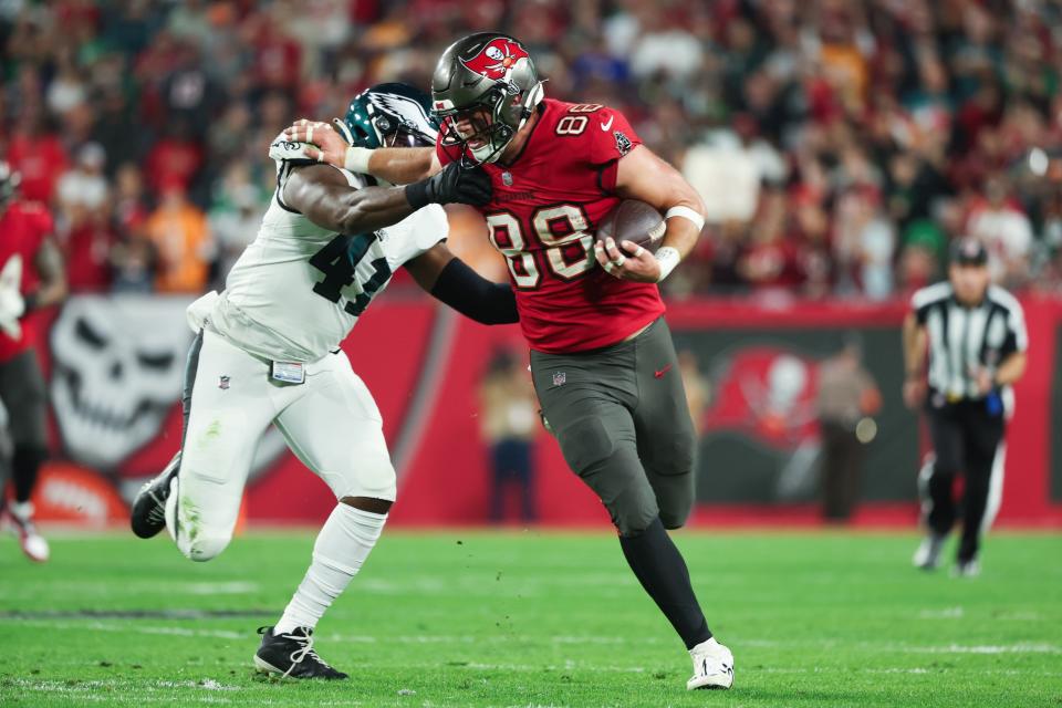 Jan 15, 2024; Tampa, Florida, USA; Tampa Bay Buccaneers tight end Cade Otton (88) fends off Philadelphia Eagles linebacker <a class="link " href="https://sports.yahoo.com/nfl/players/30633" data-i13n="sec:content-canvas;subsec:anchor_text;elm:context_link" data-ylk="slk:Nicholas Morrow;sec:content-canvas;subsec:anchor_text;elm:context_link;itc:0">Nicholas Morrow</a> (41) during the first half of a 2024 NFC wild card game at Raymond James Stadium. Mandatory Credit: Kim Klement Neitzel-USA TODAY Sports