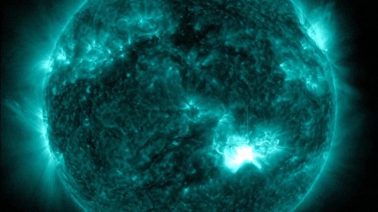  A bright flash on the sun showing where a solar flare erupted. 