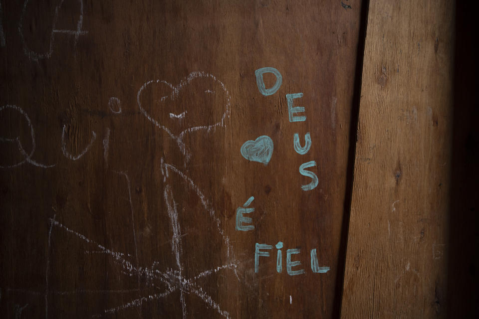 Writing in the wall of Pamela dos Santos Pereira's home reads in Portuguese "God is faithful" in Brasiliandia, one of Sao Paulo's poorest neighborhoods, in Brazil, Thursday, Sept. 29, 2022. Although this year the economy started recovering, rampant inflation put even basic foodstuffs out of people's reach and thirty-three million Brazilians experience hunger as they head into the Oct. 2nd general elections. (AP Photo/Victor R. Caivano)