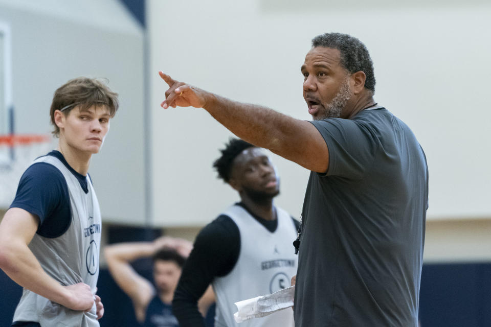 Georgetown NCAA college basketball head coach Ed Cooley, right, motions while instructing players during practice, Thursday, Oct. 19, 2023, in Washington. (AP Photo/Stephanie Scarbrough)