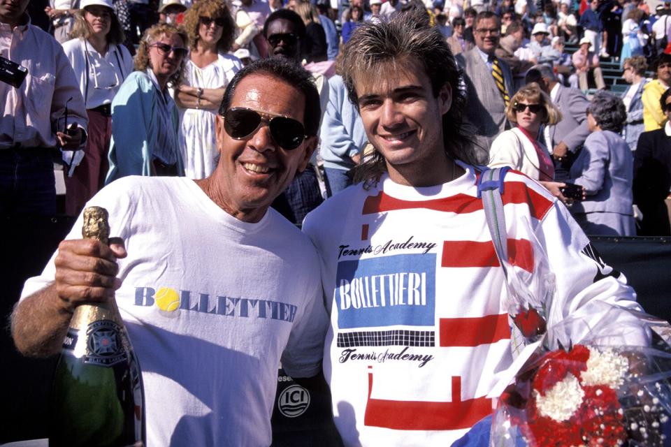 Tennis: Tournament of Champions, Closeup of Andre Agassi (R) and Nick Bollettieri (L) victorious with champagne after match, New York, NY 1/1/1988