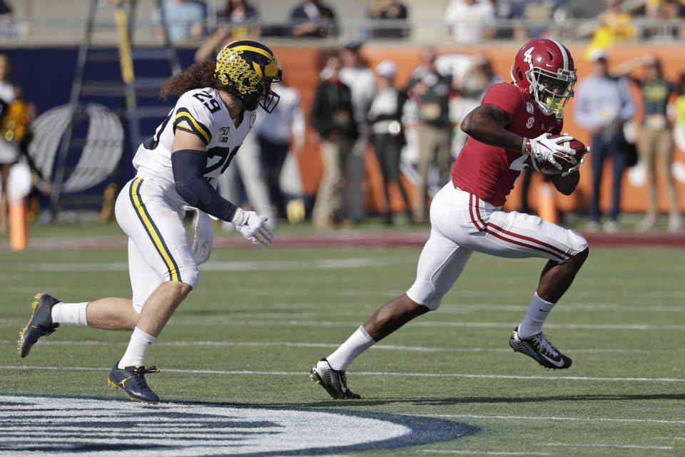 Alabama wide receiver Jerry Jeudy (4) runs after a reception past Michigan linebacker Jordan Glasgow (29) during the first half of the Citrus Bowl NCAA college football game, Wednesday, Jan. 1, 2020, in Orlando, Fla. (AP Photo/John Raoux)