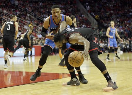 Jan 5, 2017; Houston, TX, USA; Houston Rockets guard James Harden (13) is guarded by Oklahoma City Thunder guard Russell Westbrook (0) in the third quarter at Toyota Center. Thomas B. Shea-USA TODAY Sports