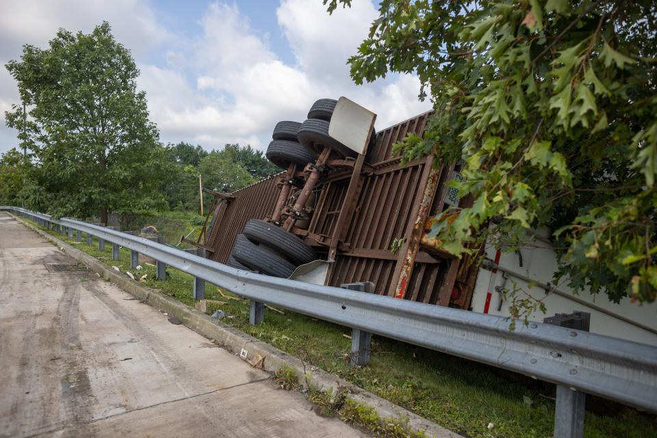 A trailer lays on it's side, flipping over a guard rail in Bensalem, on Friday, July 30, 2021. A tornado caused major damage to the area Thursday evening.