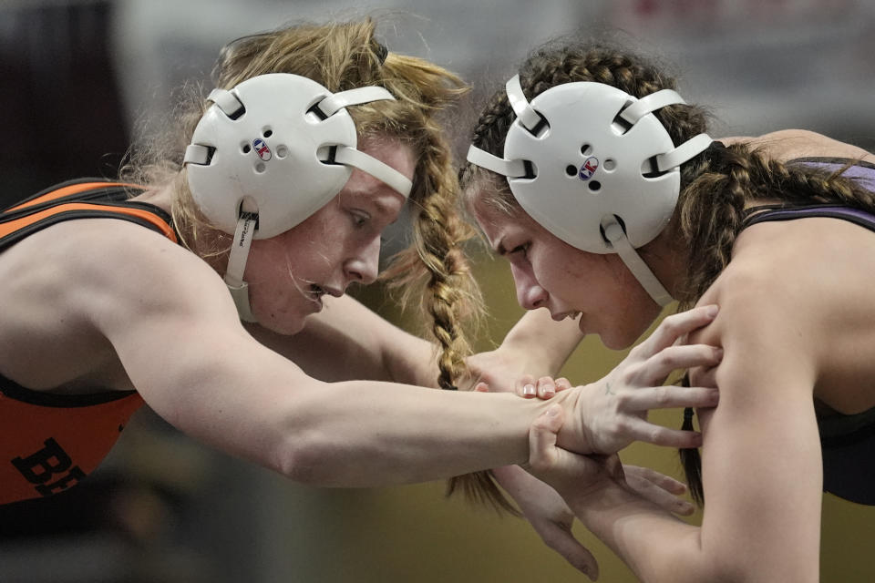 Benton's Callie Hess, left, battles Plum's Saphia Davis, right, during the first found of the PIAA High School Wrestling Championships in Hershey, Pa., Thursday, March 7, 2024. Girls’ wrestling has become the fastest-growing high school sport in the country. (AP Photo/Matt Rourke)
