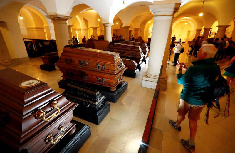 FILE PHOTO: Visitors walk beside coffins inside the crypt of the Prussian emperors - the Hohenzollern house - during a media tour to present the restoration plans of the area in the Berlin cathedral in Berlin