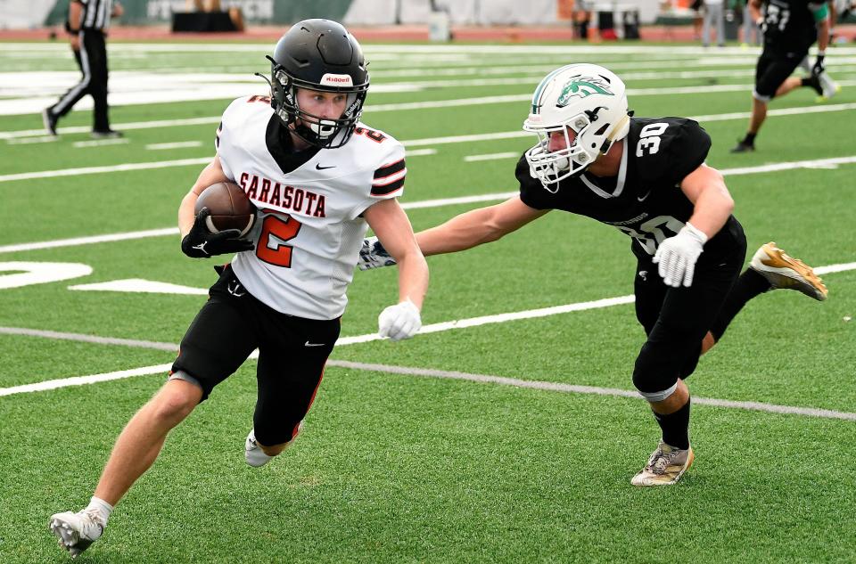 Sarasota's Lucas Crowley (#2) picks up some yardage on a short pass Friday night.