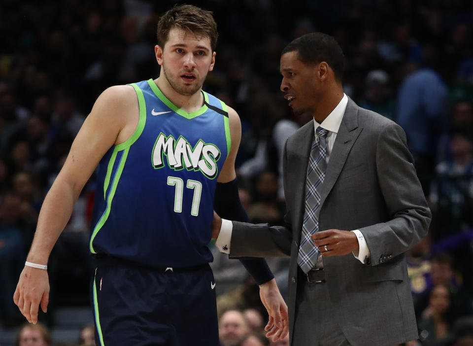 DALLAS, TEXAS - JANUARY 10:   Luka Doncic #77 of the Dallas Mavericks and assistant coach Stephen Silas at American Airlines Center on January 10, 2020 in Dallas, Texas.  NOTE TO USER: User expressly acknowledges and agrees that, by downloading and or using this photograph, User is consenting to the terms and conditions of the Getty Images License Agreement.  (Photo by Ronald Martinez/Getty Images)