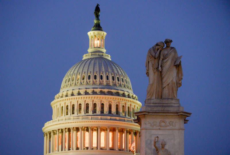 A statue representing "Grief" lays her covered face on the shoulder of the statue representing "History" on the Peace Monument near the U.S. Capitol where the Senate impeachment trial of President Donald Trump is going on in Washington