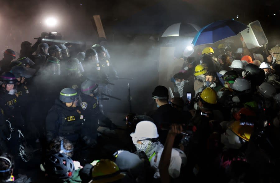 LOS ANGELES, CALIFORNIA – May 2: Police officers clash with pro-Palestinian protesters as a fire extinguisher is deployed at UCLA early Thursday morning. (Wally Skalij/Los Angeles Times via Getty Images)