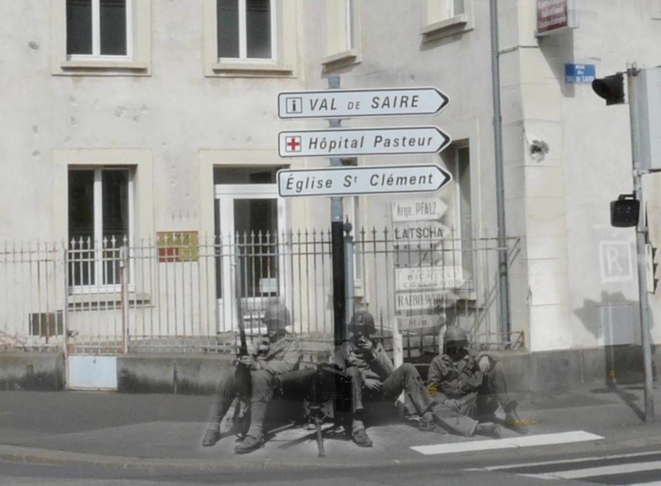 Soldiers rest against the signs to a church and a hospital. Older versions of the signs are visible below them.<br><br>(<a href="http://www.flickr.com/photos/hab3045/collections/72157629378669812/" rel="nofollow noopener" target="_blank" data-ylk="slk:Courtesy of Jo Teeuwisse" class="link ">Courtesy of Jo Teeuwisse</a>)