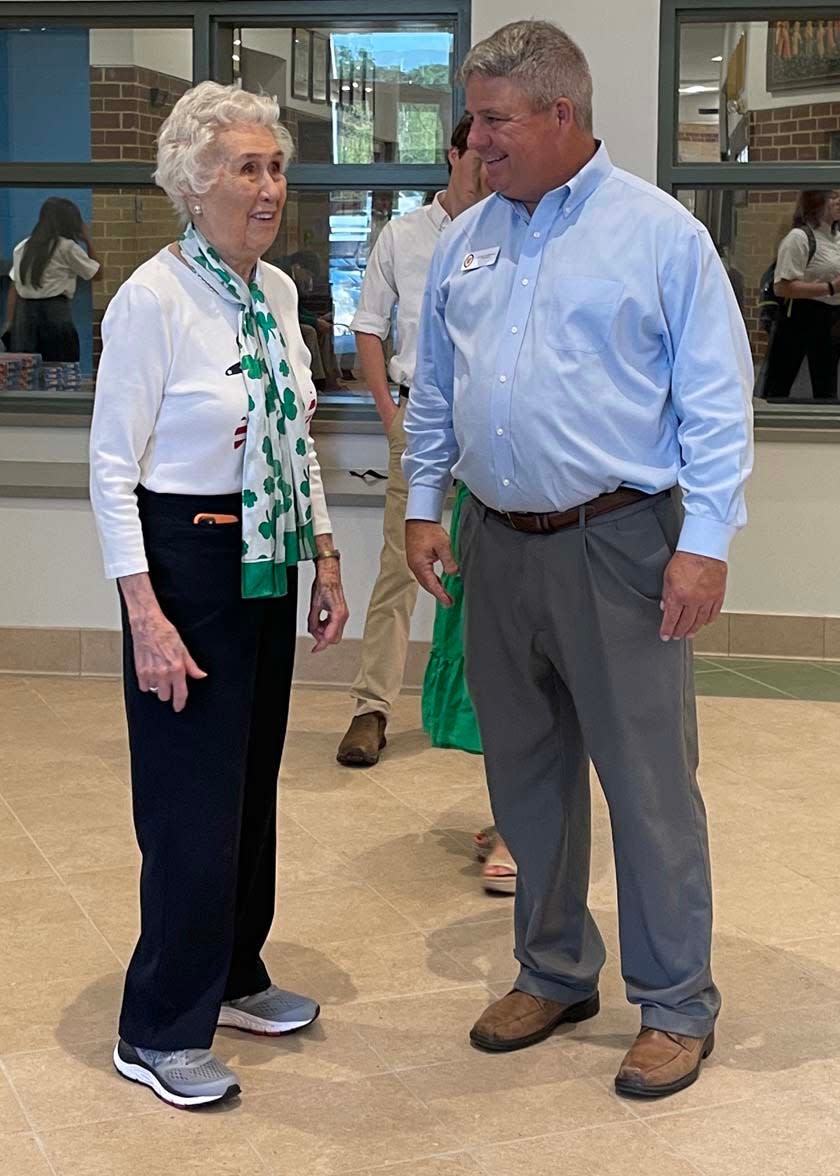 Helen Mabry Connor shares a laugh with Dickie Sompayrac, president of Knoxville Catholic High School, at a reception celebrating the school's 90th year Tuesday, Aug. 9, 2022.