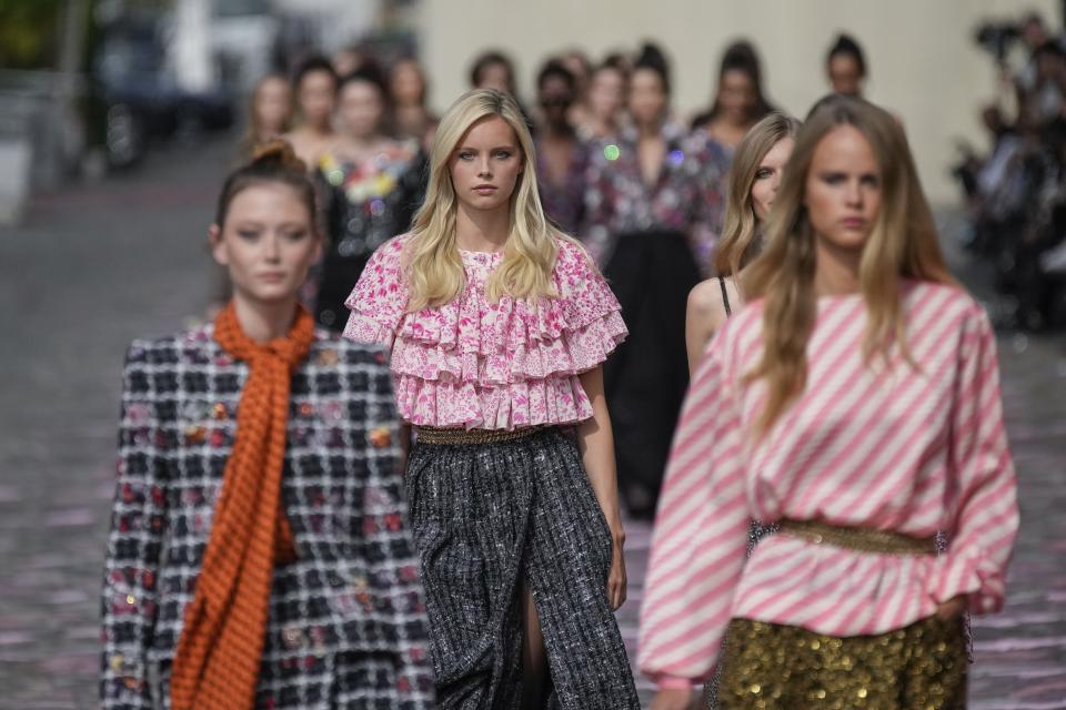 Models wear creations for the Chanel Haute Couture Fall/Winter 2023-2024 fashion collection presented in Paris, Tuesday, July 4, 2023. (AP Photo/Christophe Ena)