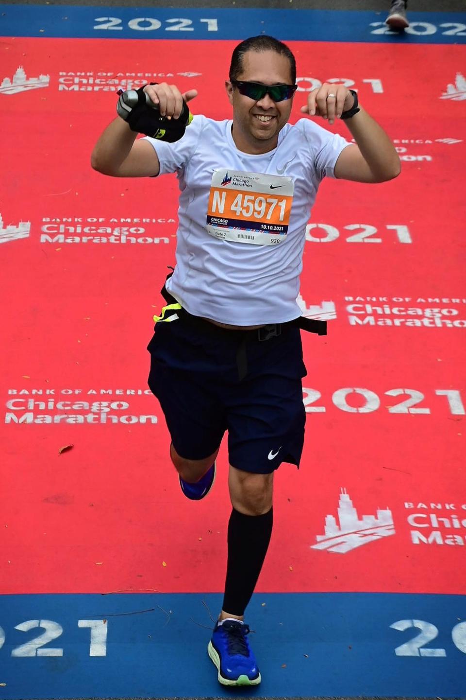 Apollo Lirio crosses the finish line at the Chicago Marathon.