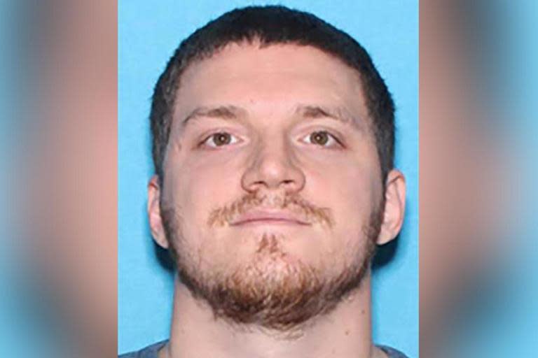 Alabama shooting: Manhunt under way as gunman in camouflage kills police officer and wounds two others