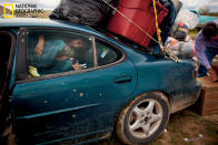 <b>Pine Ridge | August 2012 National Geographic magazine</b> <br> A passenger barely has room for the journey home as a car is loaded with used clothing donated by a Colorado-based Native American charity. Contrary to popular myth, Native Americans do not automatically receive a monthly federal check and are not exempt from taxes. The Oglala Lakota and other Sioux tribes have refused a monetary settlement for the U.S.'s illegal seizure of the Black Hills, their spiritual home. (Photo by Aaron Huey/National Geographic) <br> <br> <a href="http://photography.nationalgeographic.com/photography/photos/best-ngm-2012" rel="nofollow noopener" target="_blank" data-ylk="slk:Click here to see more images from the "Best of 2012 – National Geographic Magazine Photos of the Year.";elm:context_link;itc:0;sec:content-canvas" class="link ">Click here to see more images from the "Best of 2012 – National Geographic Magazine Photos of the Year."</a>