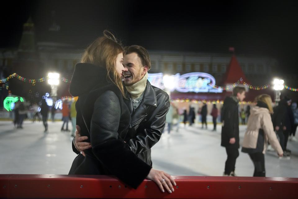 A couple enjoy the ice rink in Red Square at the Moscow GUM State Department store with the Kremlin Wall in the background in Moscow, Russia, late Monday, Feb. 14, 2022. While the U.S. warns that Russia could invade Ukraine any day, the drumbeat of war is all but unheard in Moscow, where political experts and ordinary people alike don't expect President Vladimir Putin to launch an attack on the ex-Soviet neighbor. (AP Photo/Alexander Zemlianichenko)