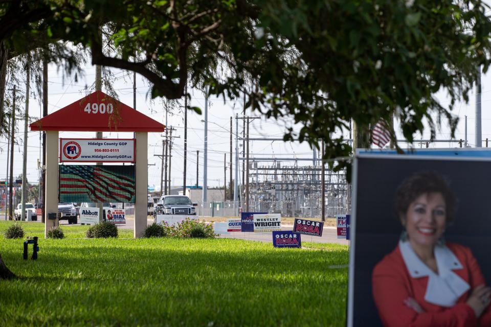 Traffic drives past campaign signs posted outside of Hidalgo County GOP headquarters, Thursday, Oct. 6, 2022, in McAllen, Texas.