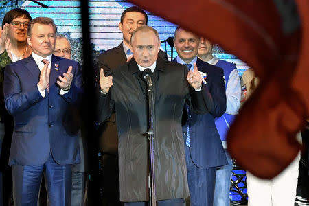 Russian President Vladimir Putin addresses the crowd during a concert marking the fifth anniversary of Russia's annexation of Crimea, in Simferopol March 18, 2019. Yuri Kadobnov/Pool via REUTERS