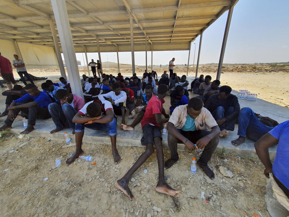 Rescued migrants rest near the city of Khoms, around 120 kilometers (75 miles) east of Tripoli, Libya., Tuesday, Aug. 27, 2019. At least 65 migrants, mostly from Sudan, were rescued, said a spokesman for Libya's coast guard, with a search halted for those still missing. The coast guard gave an estimate for those missing and feared drowned of 15 to 20 people.(AP Photo/Hazem Ahmed)