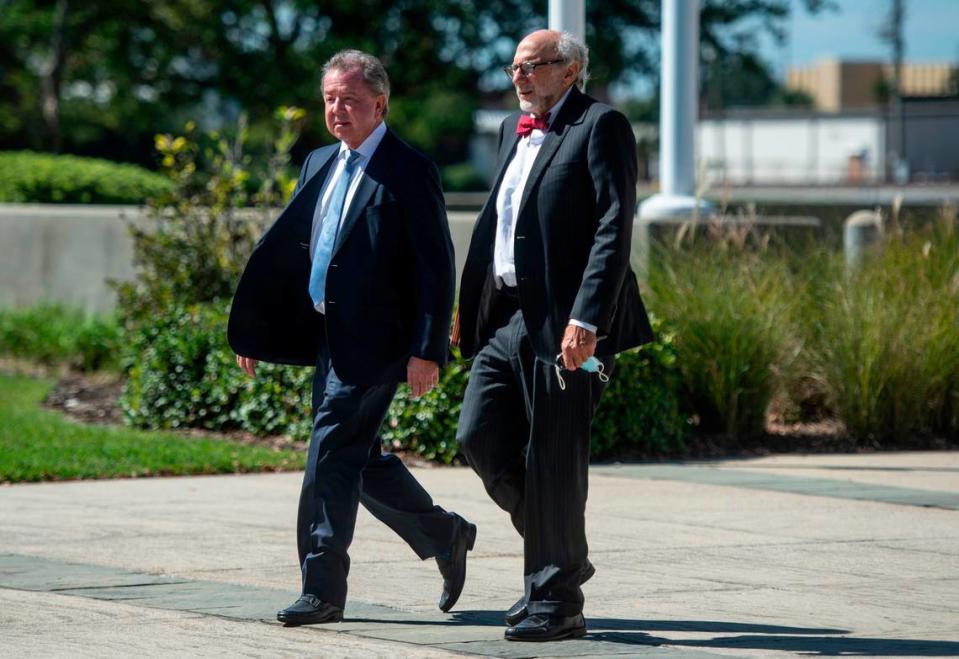 Kenneth Ritchey, left, walks out of the United States District Courthouse in Gulfport following a hearing on his charges of PPE hoarding on Monday, Sept. 27, 2021.