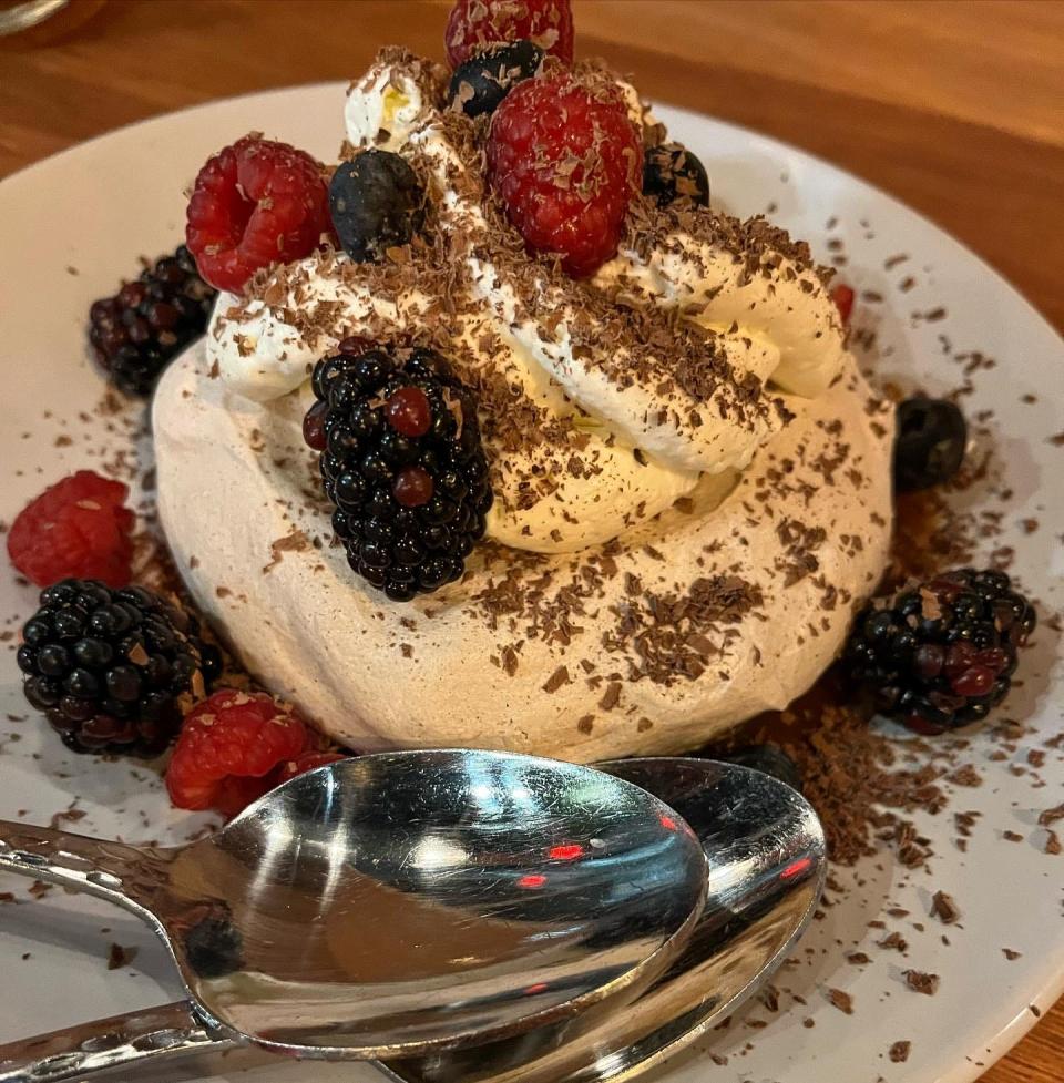 A chocolate Pavlova with coconut pandan cream, berries, and salted caramel coffee sauce at Harvey's restaurant in Louisville.