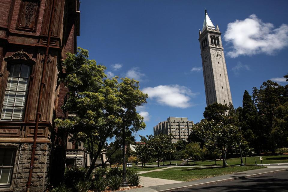 The UC–Berkeley campus, including a tower with a clock and a brown brick building.