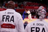 <p>France's Teddy Riner (L) and France's Romane Dicko (R) attend the bout between France's Margaux Pinot (C, R) and Israel's Gili Sharir (blue) during the judo mixed team's quarterfinal during the Tokyo 2020 Olympic Games at the Nippon Budokan in Tokyo on July 31, 2021. (Photo by Jack GUEZ / AFP)</p> 